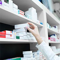 hand taking a pill box from the shelf