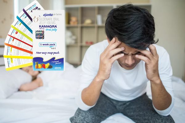 man with head in his hands and kamagra oral jelly pack
